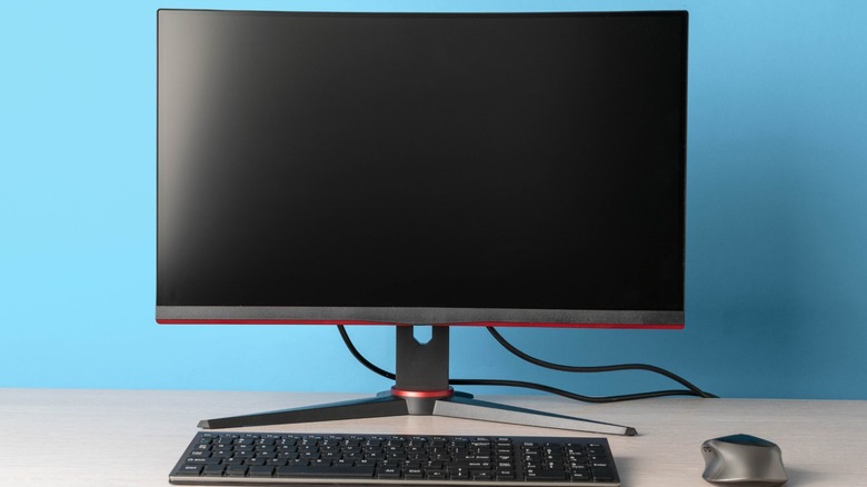 A gaming monitor with a keyboard and mouse