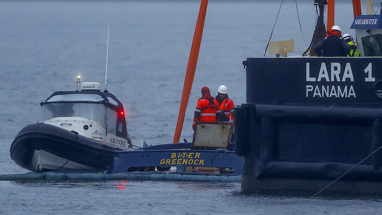 The crane ship Lara 1, from Liverpool, starts the salvage operation to recover the tugboat that capsized in the River Clyde