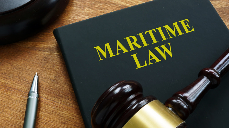 Maritime law black book and wooden gavel.
