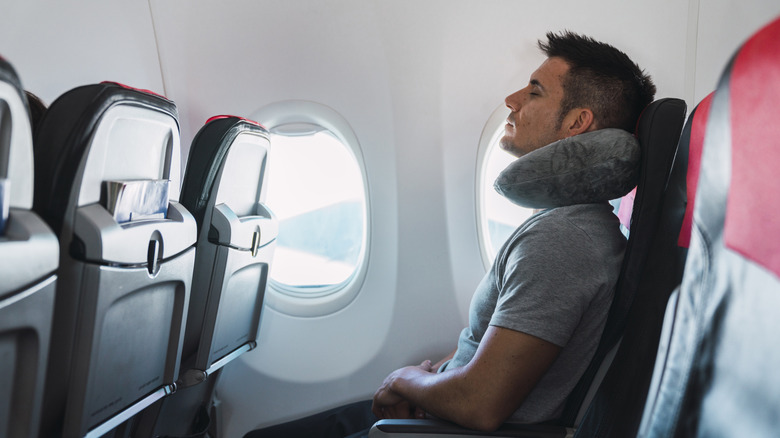 Man sleeping on flight