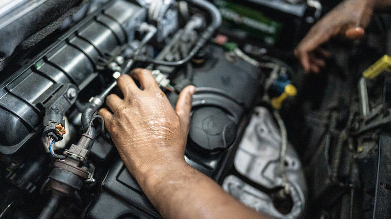 Mechanic's hands working on car engine