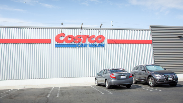 The Exterior Of A Costco Car Wash With Two Vehicles Parked In Front