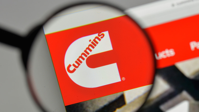 Close-up of Cummins logo under a magnifying glass
