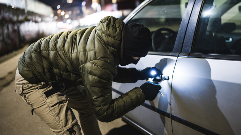 person breaking into car