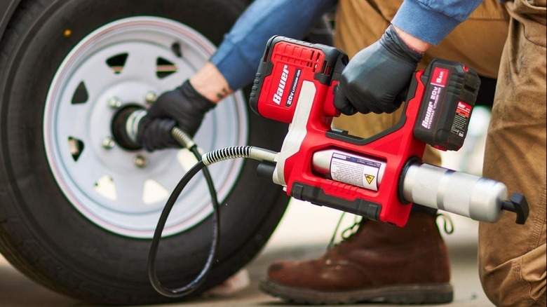 Using the Bauer 20V cordless variable-speed grease gun from Harbor Freight to grease a trailer's axle bearings.