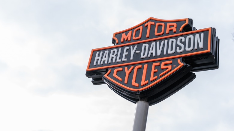 Harley-Davidson sign against a cloudy sky