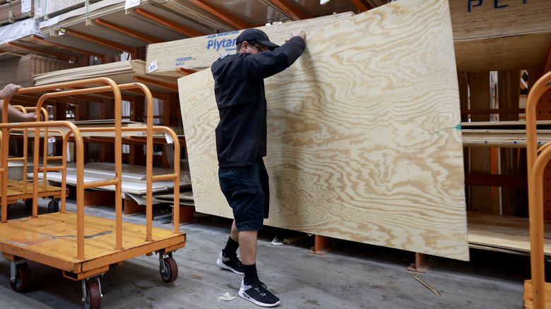Home Depot customer grabbing big wood panel