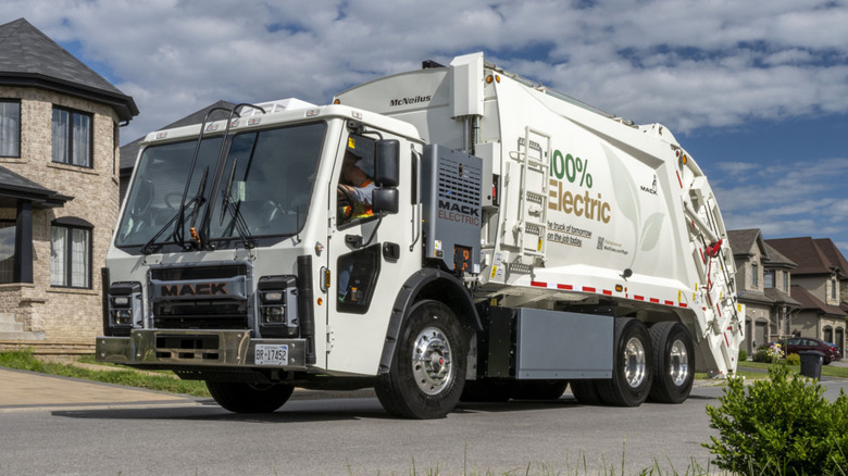 Front 3/4 view of Mack LR Electric garbage truck on its route