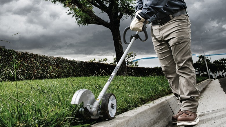 Person using a 40V Max XGT Cordless Edger on street side