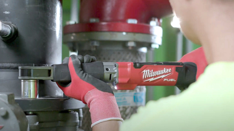Person using Milwaukee digital torque wrench