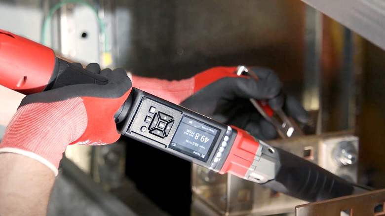 Person using Milwaukee digital torque wrench