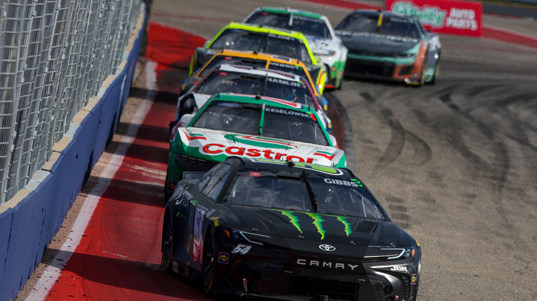 front view of line of NASCAR stock cars racing at Circuit of the Americas