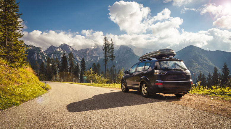 Car driving on mountain path.