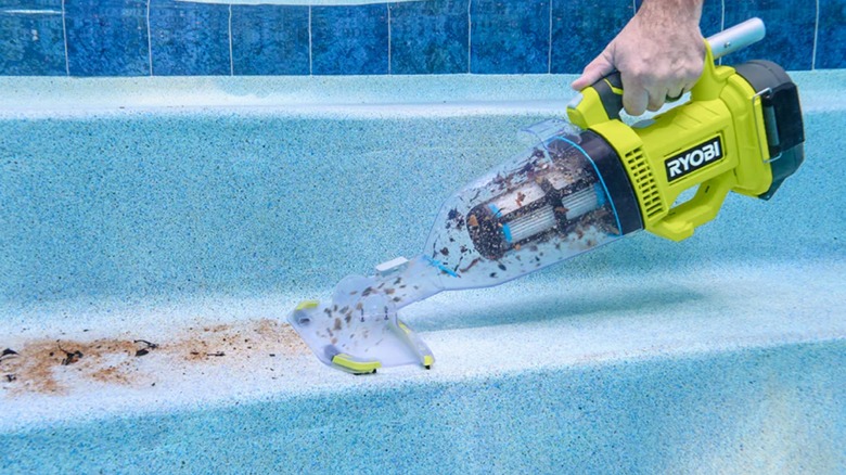 Hand holding Ryobi pool vacuum