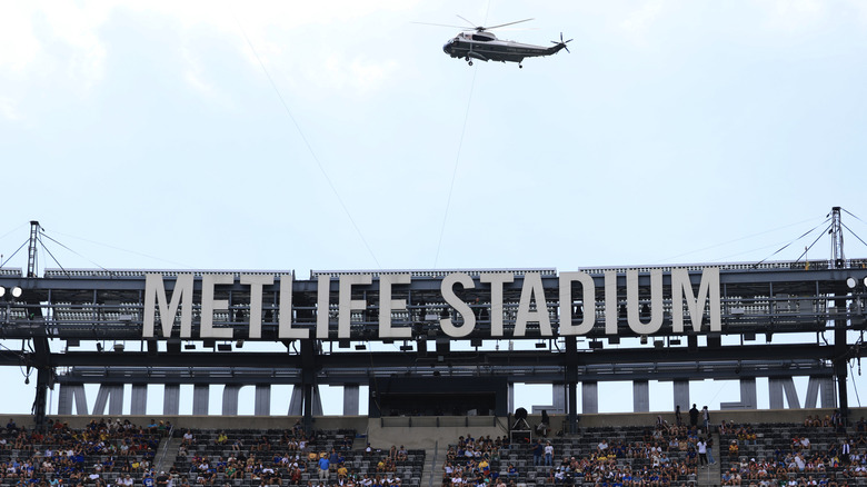 Helicopter flying over Metlife Stadium during the day