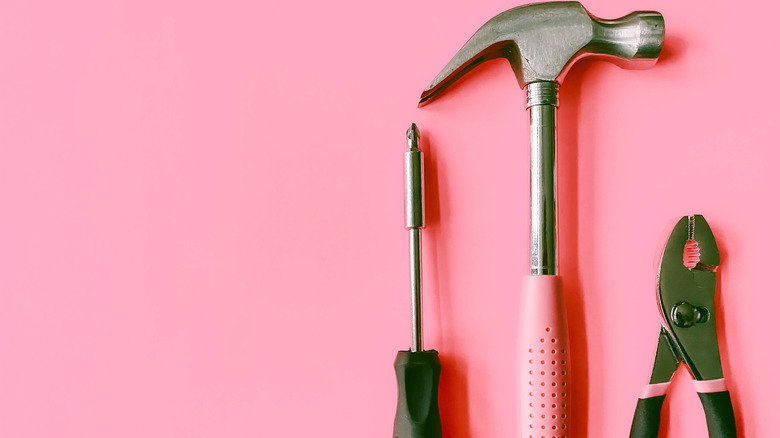 Pink-accented tools on a pink background