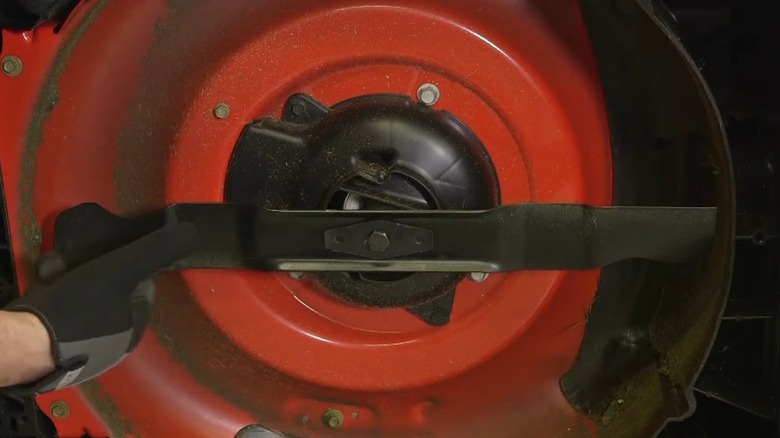 The Underside Of A Mowers Cutting Deck With Blade And Bolt Visible