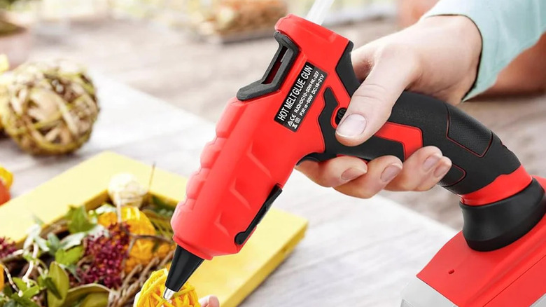 person using a LIVOWALNY cordless hot glue gun for crafting
