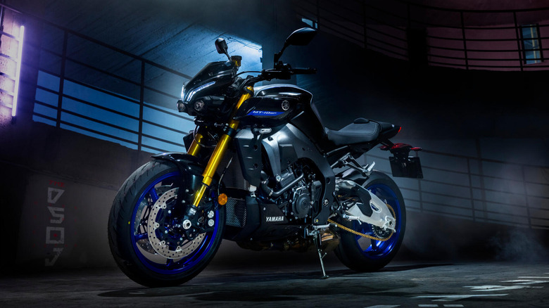A front 3/4 shot of the Yamaha MT-10 at night time with an industrial backdrop