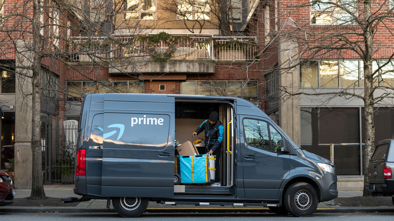 Amazon delivery person unloads package from truck