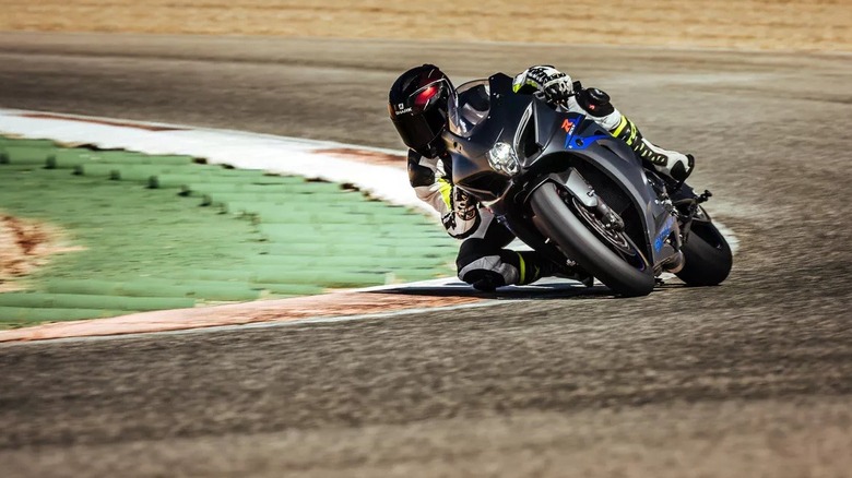 A rider leaning a sportbike into a corner on a race track