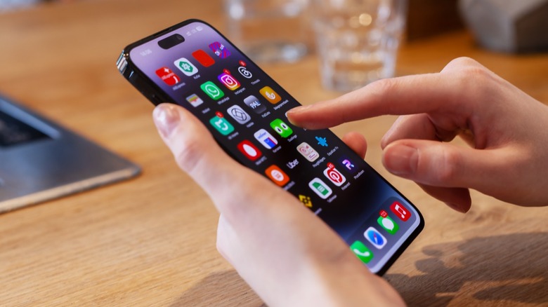 Person clicking apps on iPhone