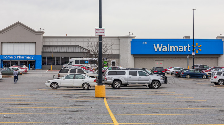 A Walmart store parking lot with cars and one person in Hickory, NC.