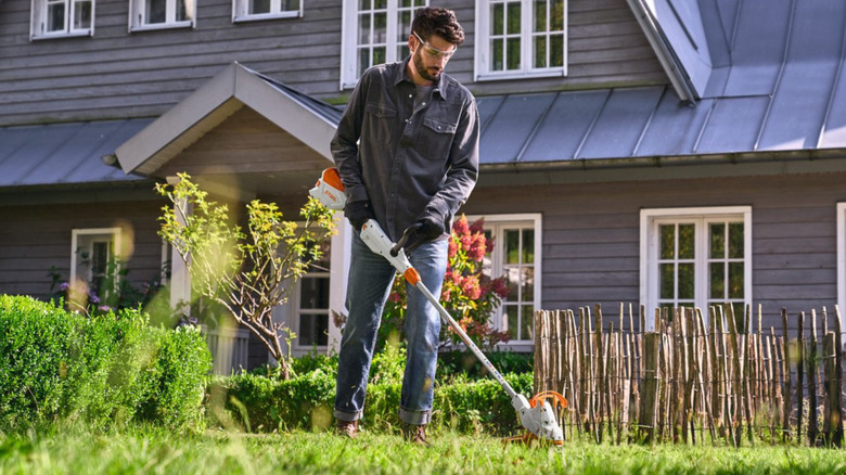 A man using a Stihl weed eater