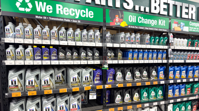 A shop motor oil stand with a sign that says "we recycle".