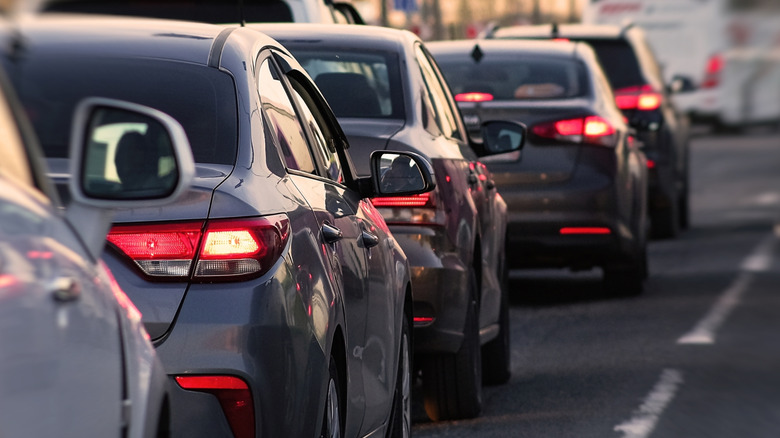 Several cars with illuminated brakelights in stop and go traffic