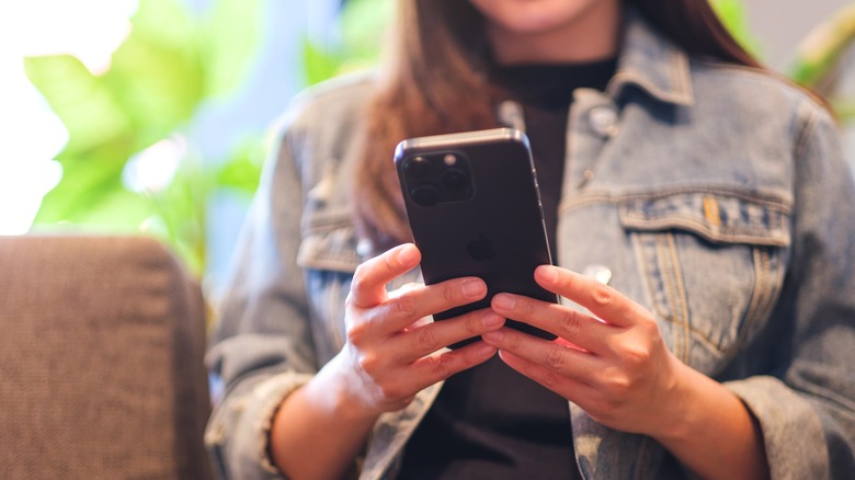 woman using iphone 15 pro max