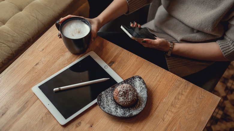 woman using iPhone with Apple Pencil and iPad