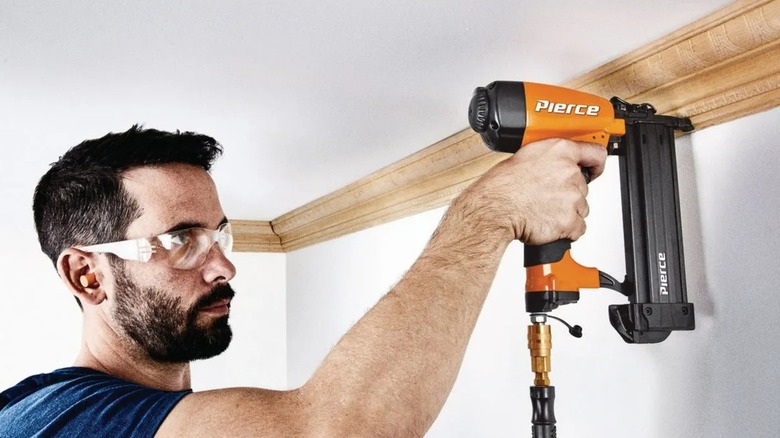 Someone using a Pierce 18 Gauge brad nailer.