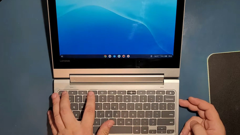 Pressing buttons on a Chromebook on a table