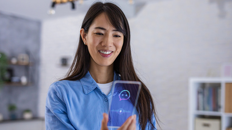 A woman holding a transparent phone