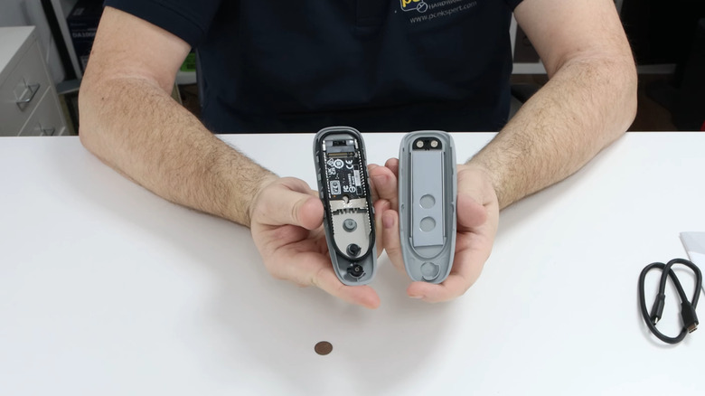 A man holding opened SSD enclosure in hands