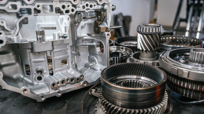 Close up view of auto transmission components on workbench.
