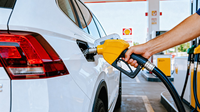 man pumping gas at shell station