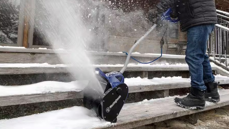 A person uses a Westinghouse corded snow shovel