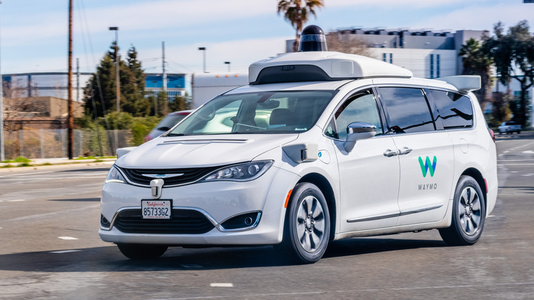 White Chrysler Pacifica Hybrid working as a Waymo unit