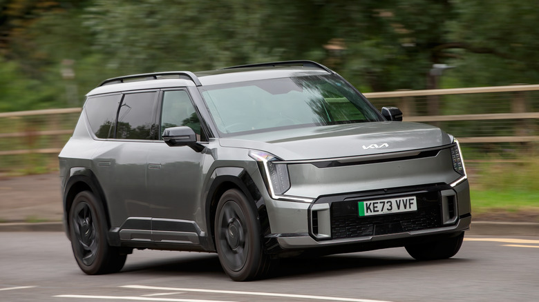 Gray Kia EV9 speeding on a road in the UK