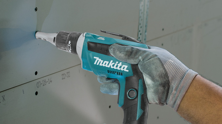 person using makita drywall screwdriver