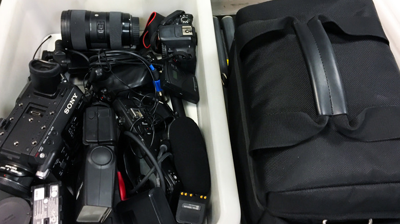 TSA bin with camera equipment