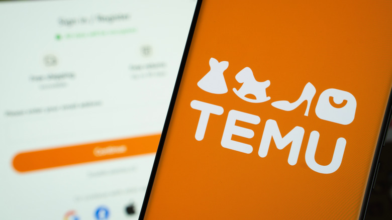 Temu logo is displayed on a smartphone screen, with the temu login page visible on a computer screen in the background.