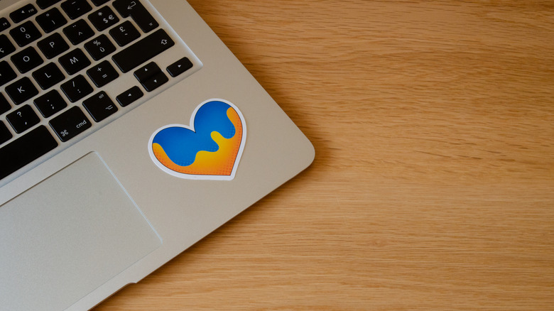 Laptop with heart sticker on palm rest