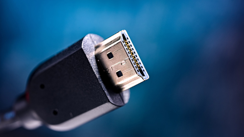 Close up of an HDMI connector with a blue background.