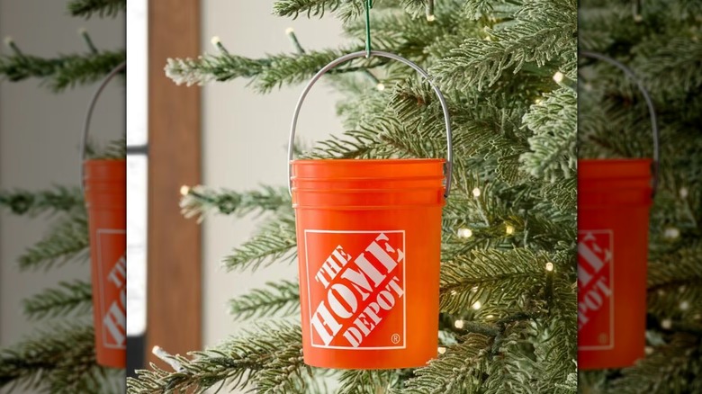 An orange mini bucket from Home Depot hanging in a Christmas tree.