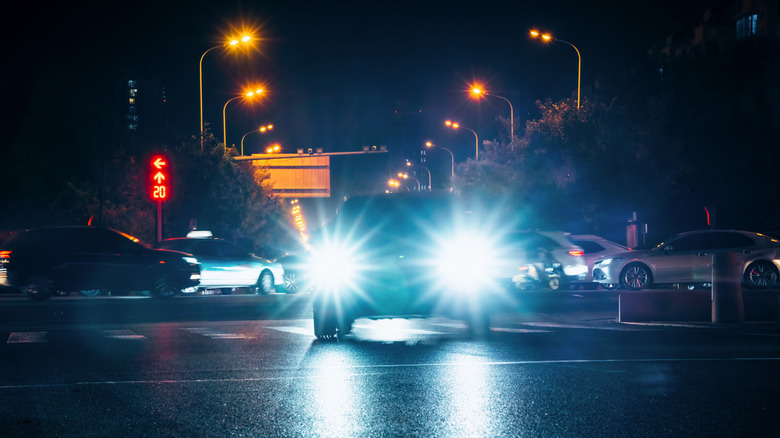 Front-view of vehicle with bright LED headlights with high-beams on at night