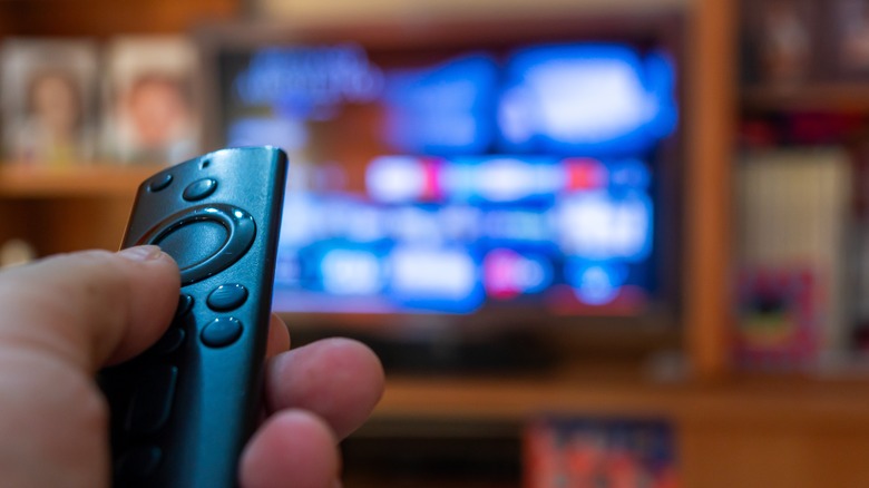 Fire TV stick remote near a TV