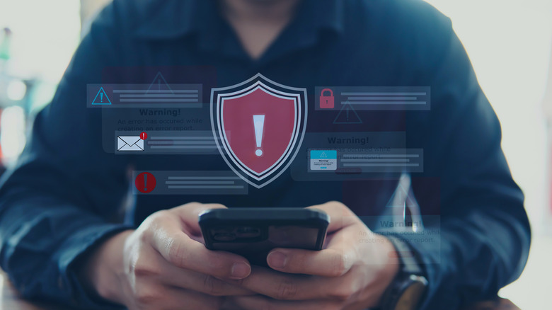 An infographic showing various warning messages, person using a smartphone in the background